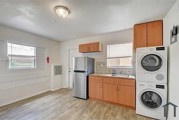 a kitchen with stainless steel appliances a refrigerator and a sink