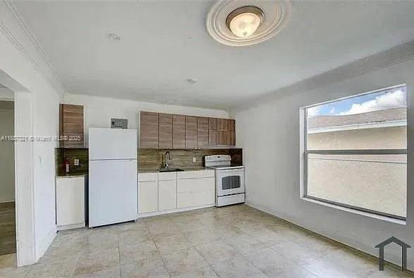 a view of a kitchen with electric appliances
