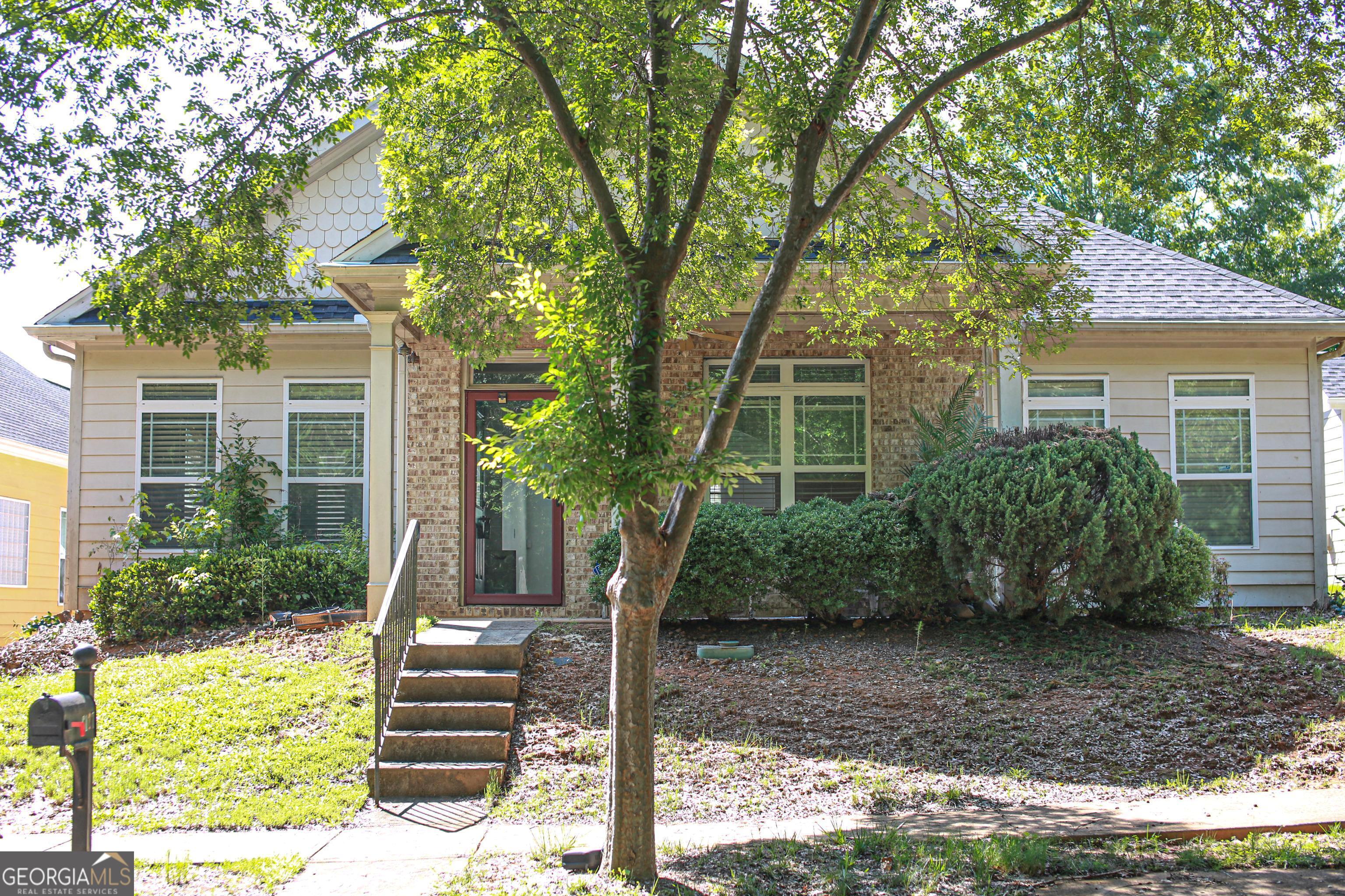 a front view of a house with garden