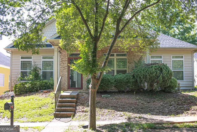 a front view of a house with garden