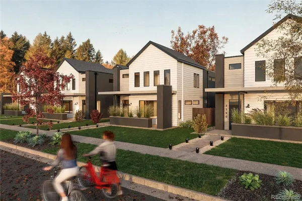 a front view of a house with a yard and trees