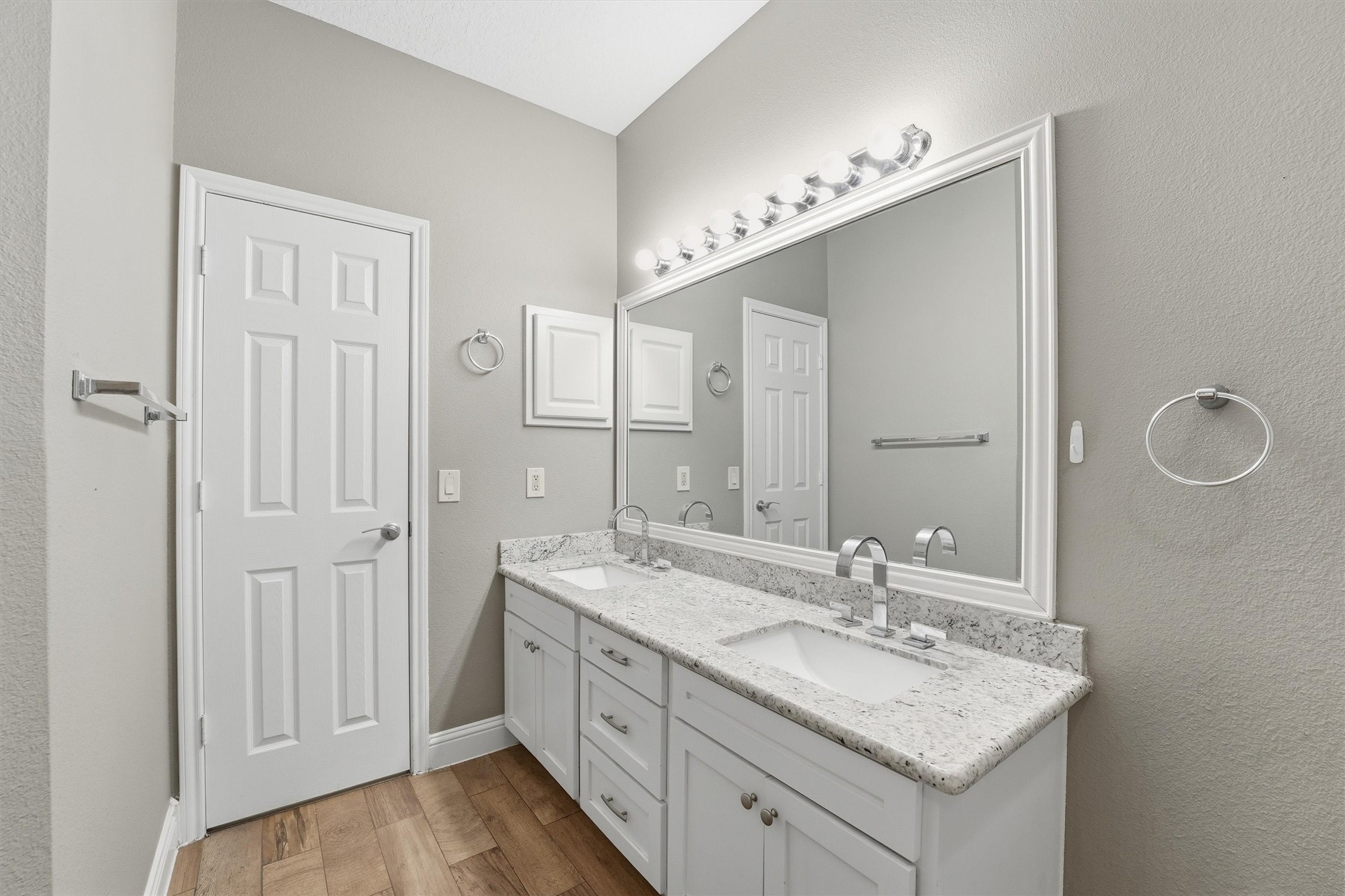 5719 Walkabout Way Katy, TX 77450 - Photo 15 of 25 The ensuite bath delivers a spa-like experience with double sinks, framed mirrors, and bright white cabinetry.