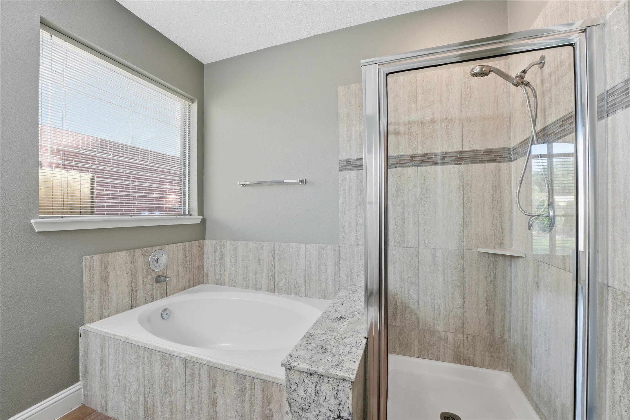 5719 Walkabout Way Katy, TX 77450 - Photo 16 of 25 A soaking tub invites long, relaxing evenings, while the separate tiled shower offers a sleek, modern touch.