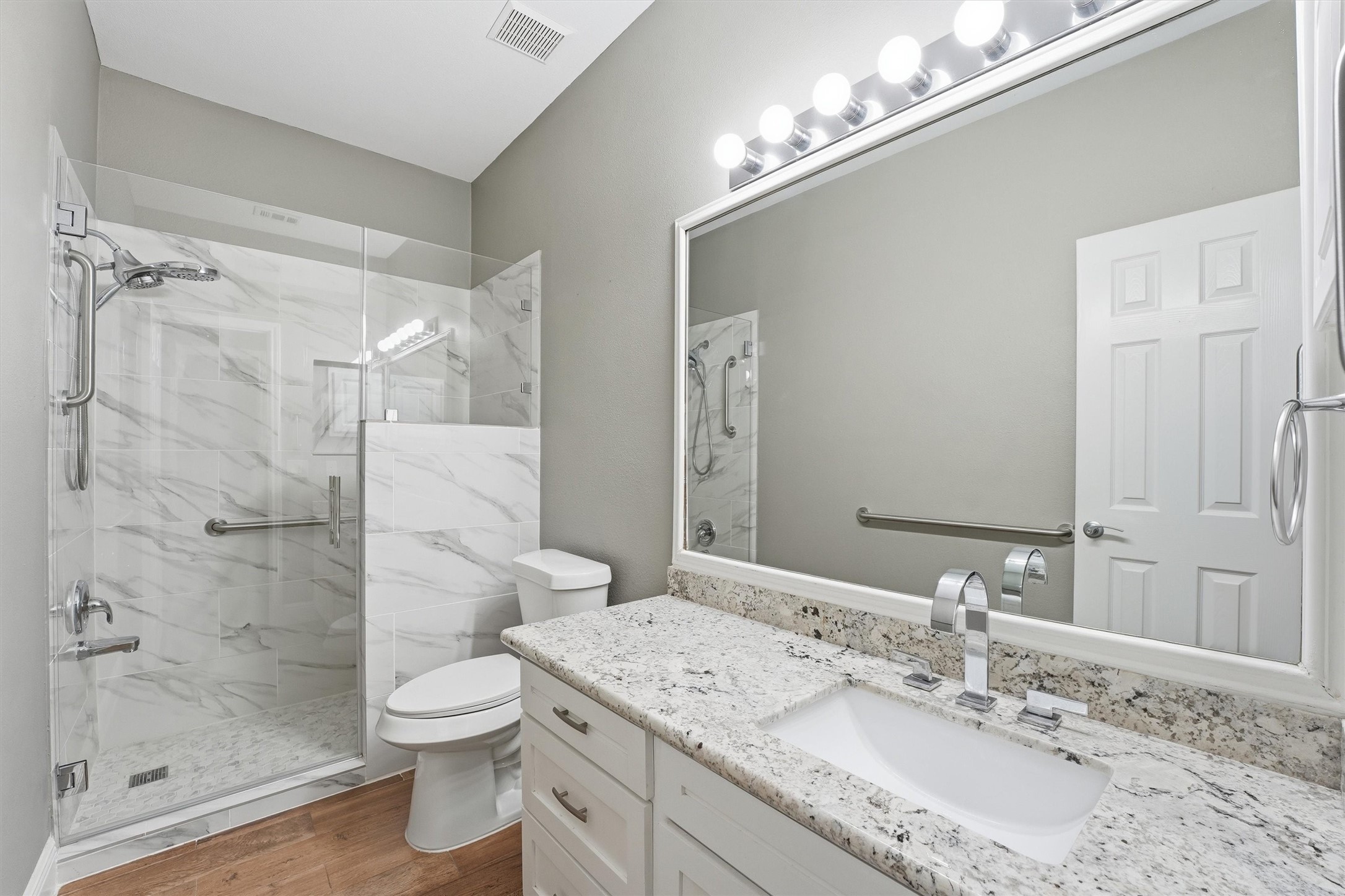 5719 Walkabout Way Katy, TX 77450 - Photo 19 of 25 The secondary bath stands out with its granite countertop, tiled walk-in shower and frameless glass door, giving it a clean, modern feel. It’s both stylish and functional, perfect for everyday use or hosting guests.