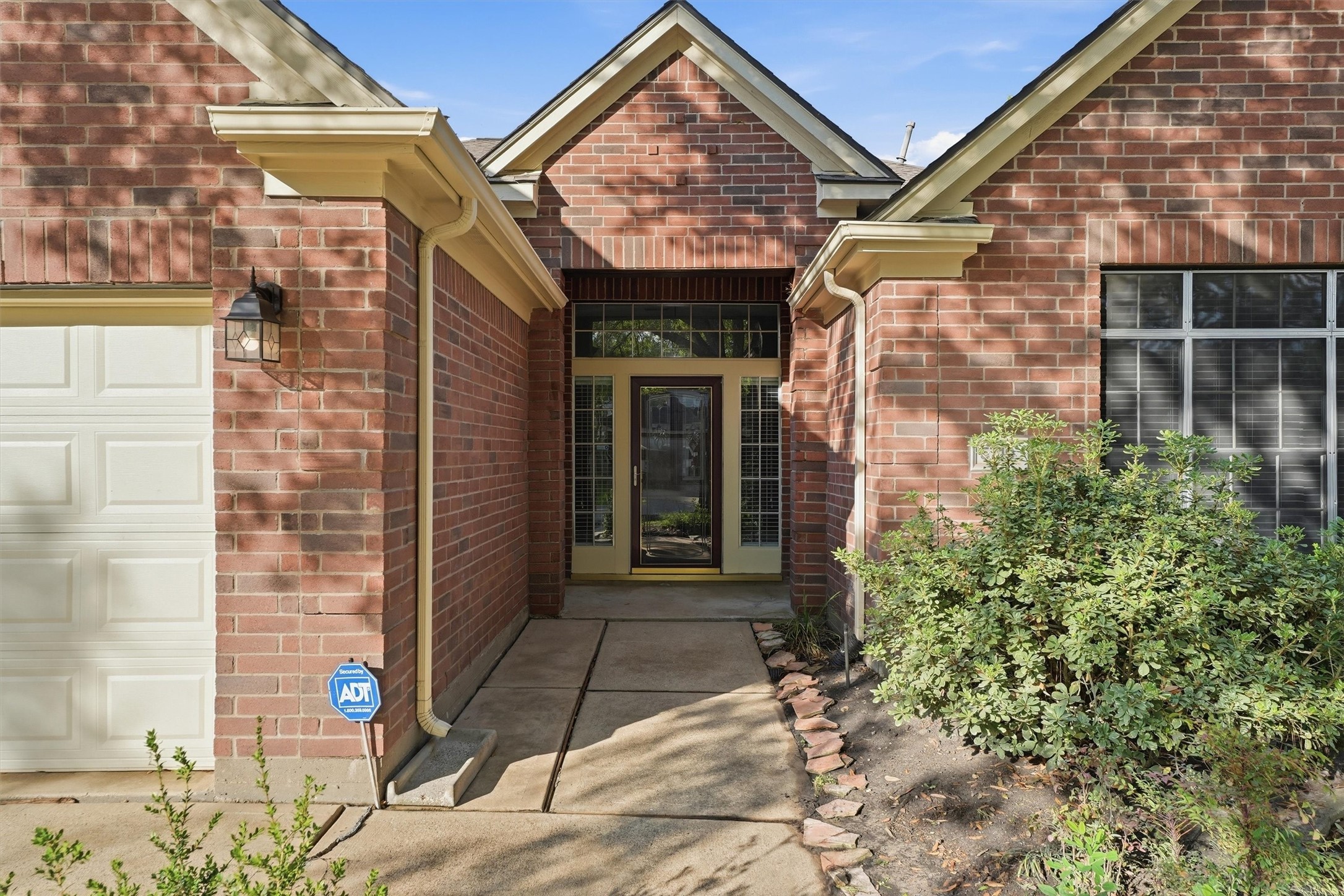 5719 Walkabout Way Katy, TX 77450 - Photo 2 of 25 The storm door paired with the glass front door featuring a wrought iron inlay creates a grand yet welcoming entrance.