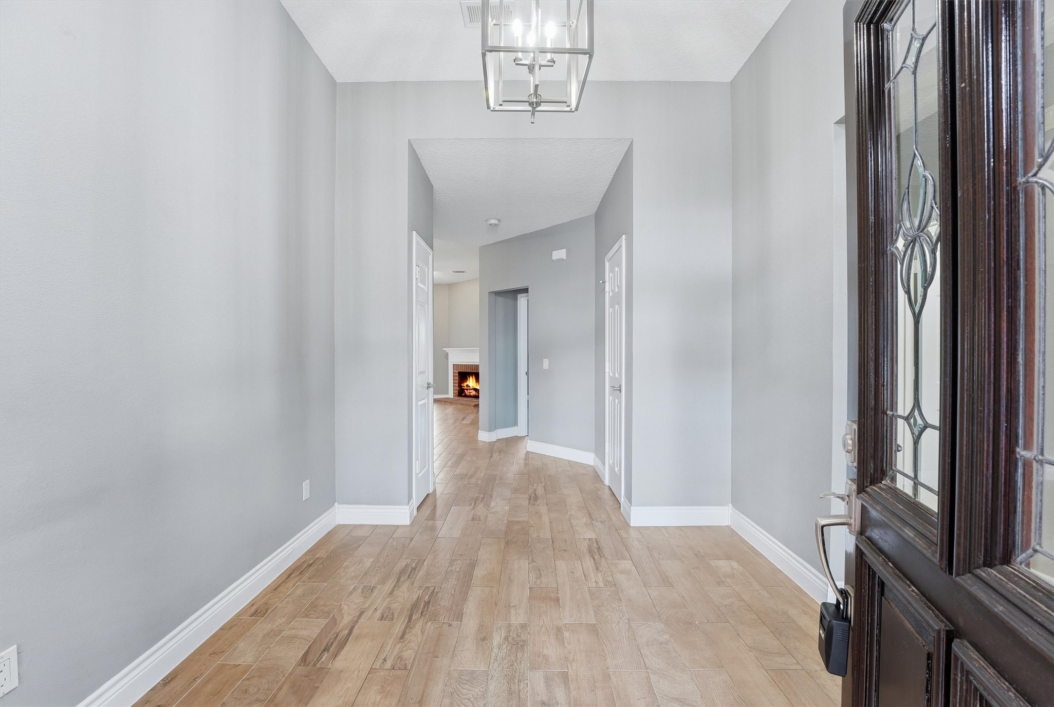 5719 Walkabout Way Katy, TX 77450 - Photo 3 of 25 Step inside and you’re greeted by wood-look tile that flows seamlessly throughout, creating a cohesive and elevated feel. Extended baseboards add a subtle custom touch that doesn’t go unnoticed.