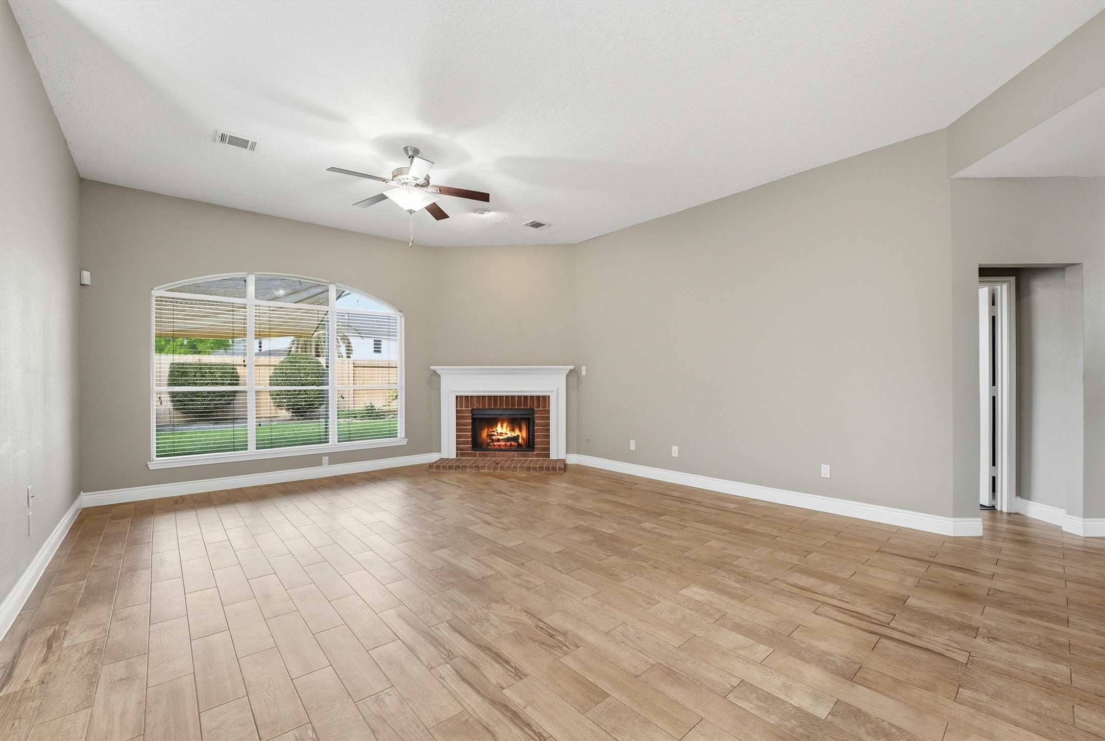 5719 Walkabout Way Katy, TX 77450 - Photo 5 of 25 The heart of the home opens up in a big way. A wall of windows stretches across the back, pulling in natural light and offering peaceful backyard views.