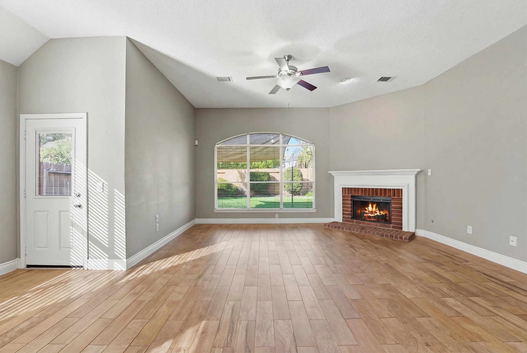 5719 Walkabout Way Katy, TX 77450 - Photo 6 of 25 The brick fireplace anchors the space, ready for cozy nights or relaxed gatherings.