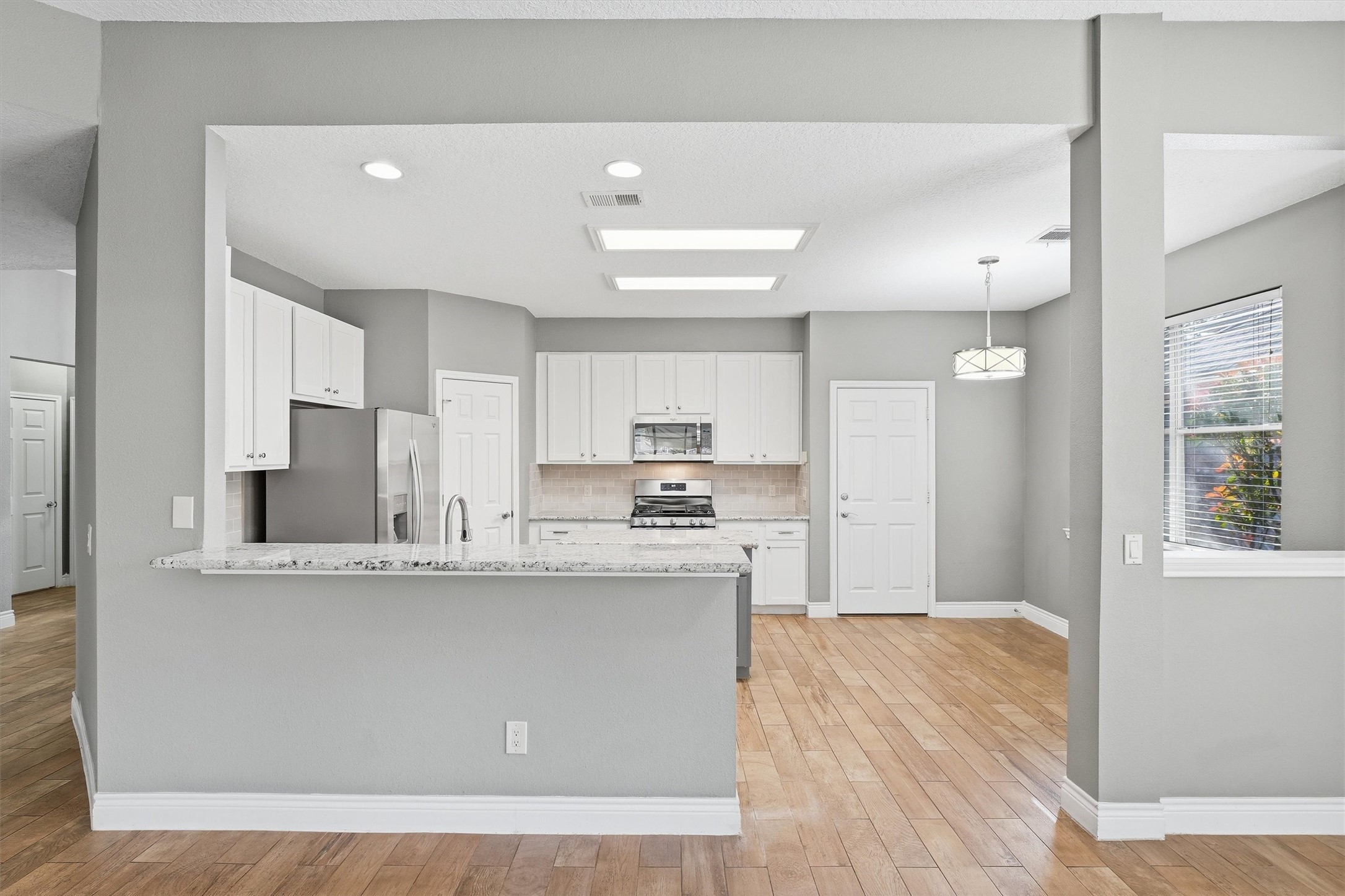 5719 Walkabout Way Katy, TX 77450 - Photo 9 of 25 The breakfast bar is perfect for quick meals, morning coffee, or gathering with friends while meals come together.