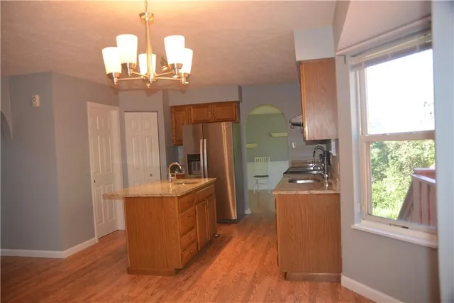 a view of a dining room with furniture a chandelier and wooden floor