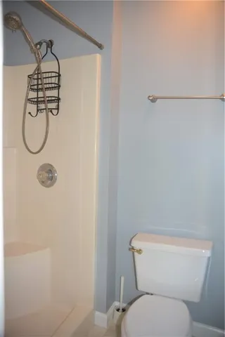 a bathroom with a toilet and a shower