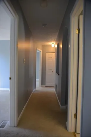 an empty room with closet and a ceiling fan