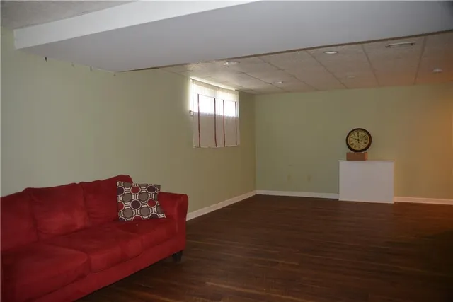 a view of a house with backyard and wooden fence
