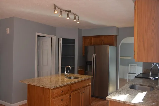 a kitchen with a refrigerator and a sink