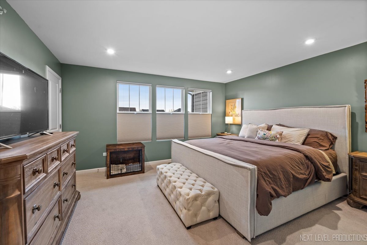 1255 Josiah Road Naperville, IL 60563 - Photo 16 of 39 a bedroom with a bed and a flat screen tv