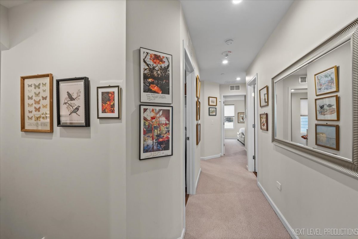 1255 Josiah Road Naperville, IL 60563 - Photo 22 of 39 a view of a hallway with paintings on the wall