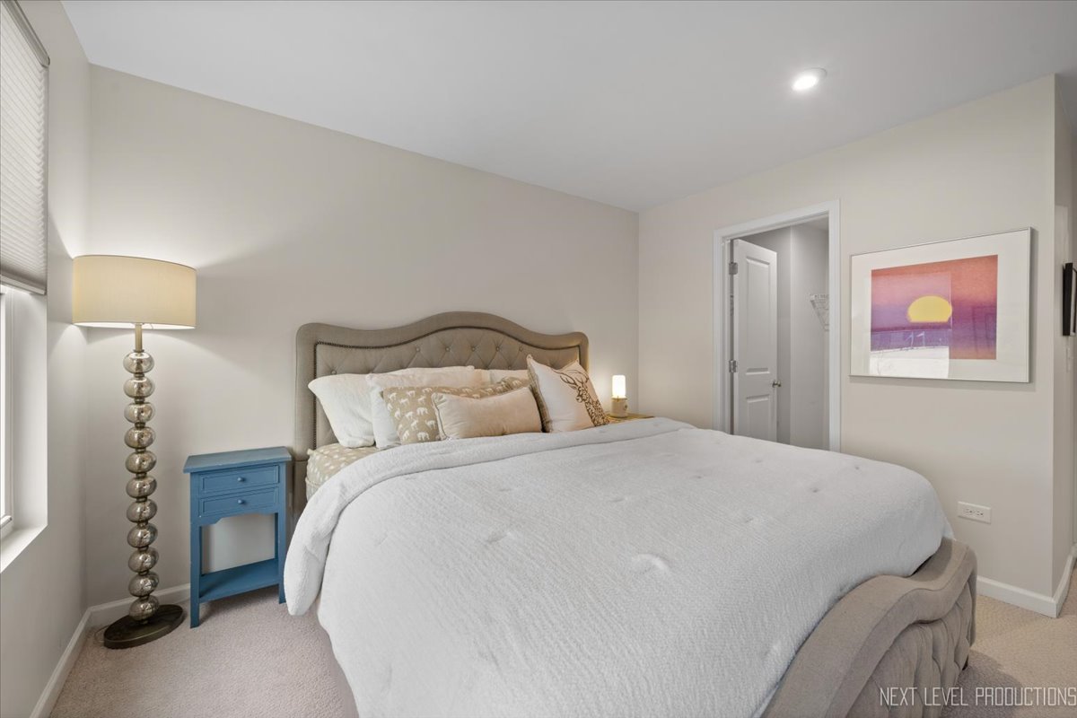 1255 Josiah Road Naperville, IL 60563 - Photo 26 of 39 a bedroom with a bed and a lamp