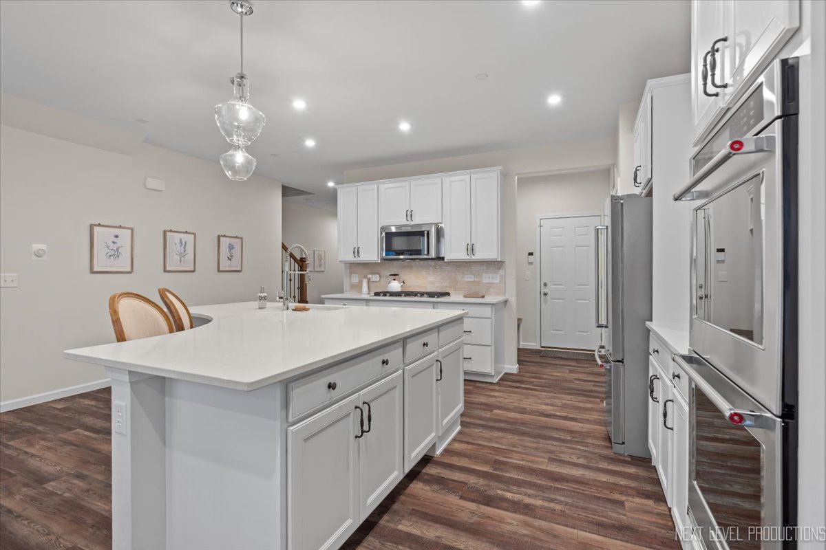 1255 Josiah Road Naperville, IL 60563 - Photo 6 of 39 a large white kitchen with a sink a refrigerator and a stove