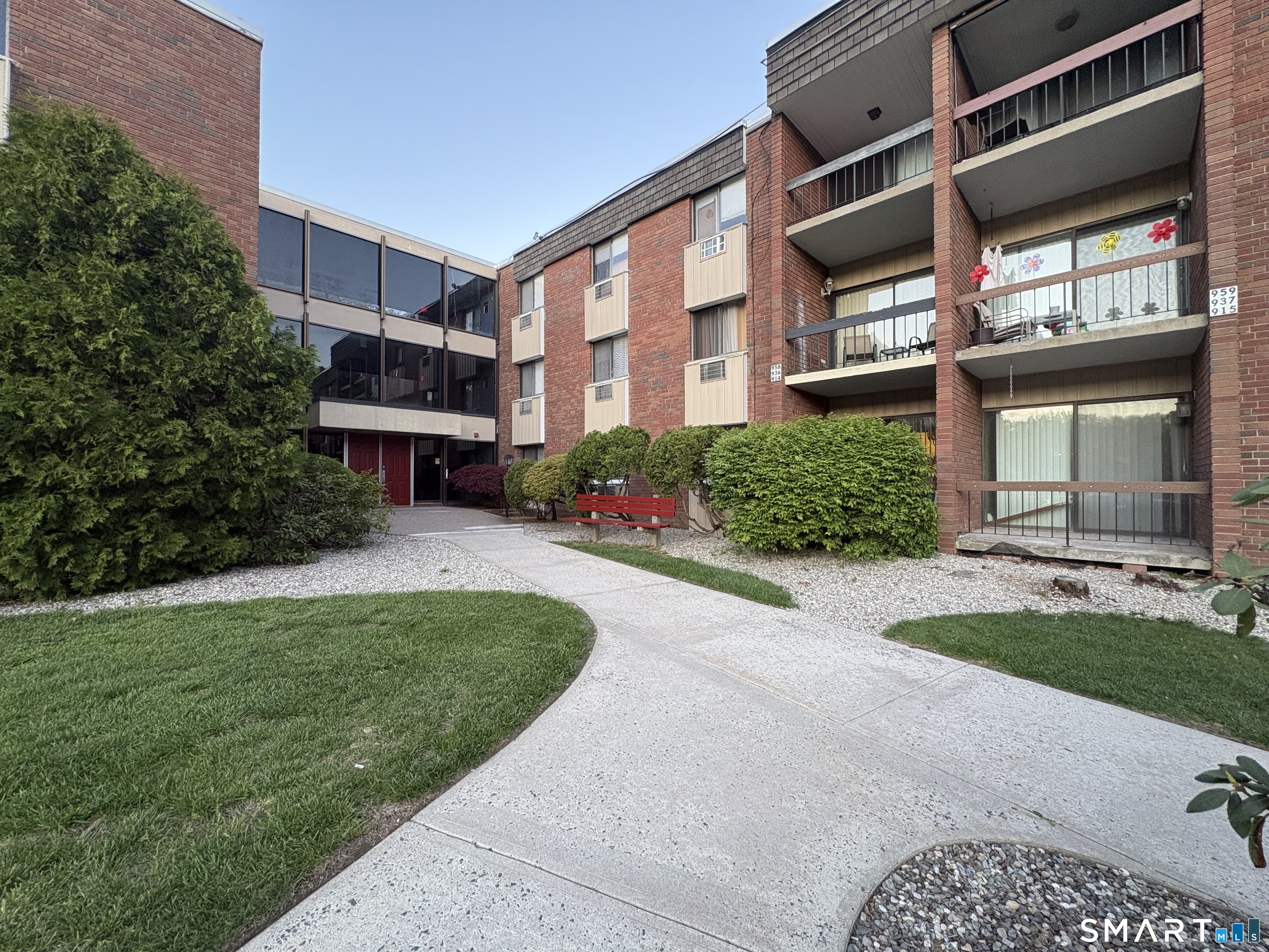 914 High Path Road, Unit 914 Windsor, CT 06095 - Photo 19 of 23 a front view of a house with a yard and outdoor seating