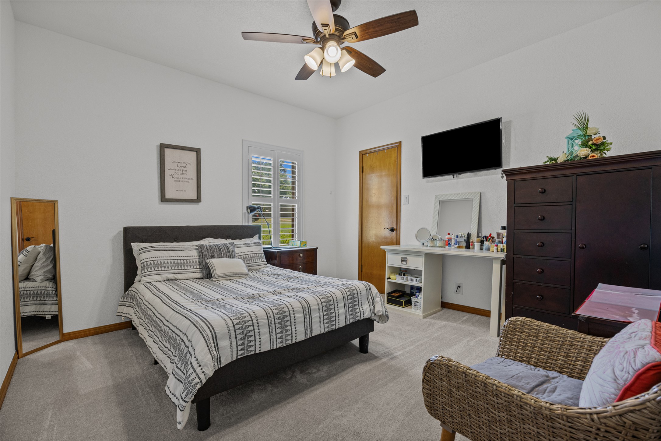 2000 Spinel Road Pflugerville, TX 78660 - Photo 12 of 31 A naturally illuminated bedroom offers comfort with plush carpeting and a convenient ceiling fan for ultimate relaxation.