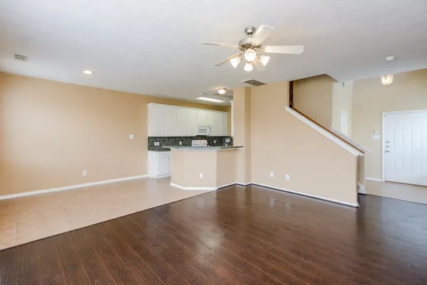 a view of a kitchen with a sink wooden floor and a kitchen