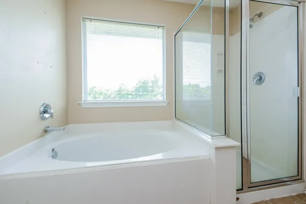 a white bath tub sitting next to a window