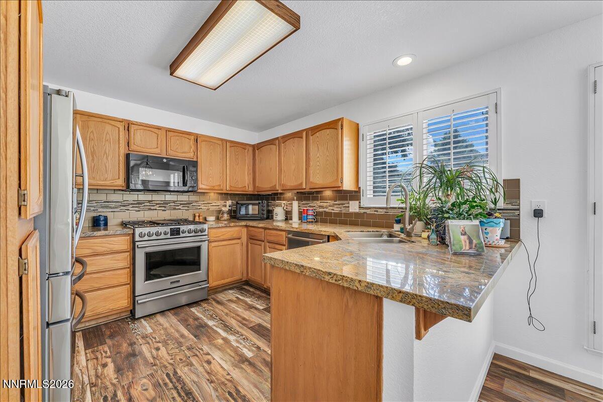 10 Eagle Claw Court Reno, NV 89523 - Photo 17 of 36 a kitchen with granite countertop stainless steel appliances a stove sink and cabinets