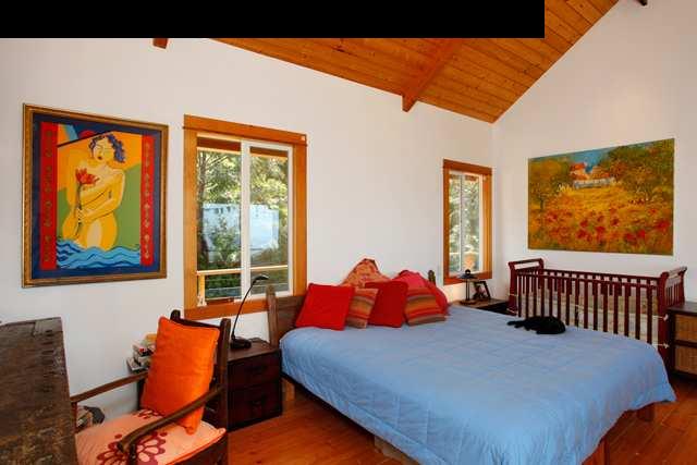 429 Omaopio Road Kula, HI 96790 - Photo 17 of 27 a bed sitting in a bedroom next to a window