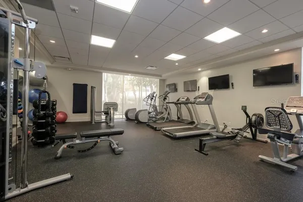 a bathroom with a granite countertop sink a toilet and a mirror