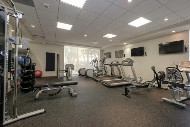 a bathroom with a granite countertop sink a toilet and a mirror