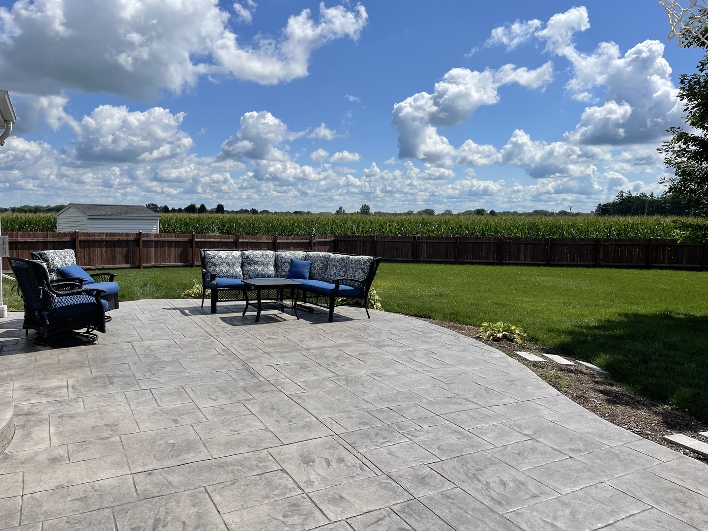 136 Reston Court Sycamore, IL 60178 - Photo 36 of 50 a view of a patio with dining table and chairs with a yard