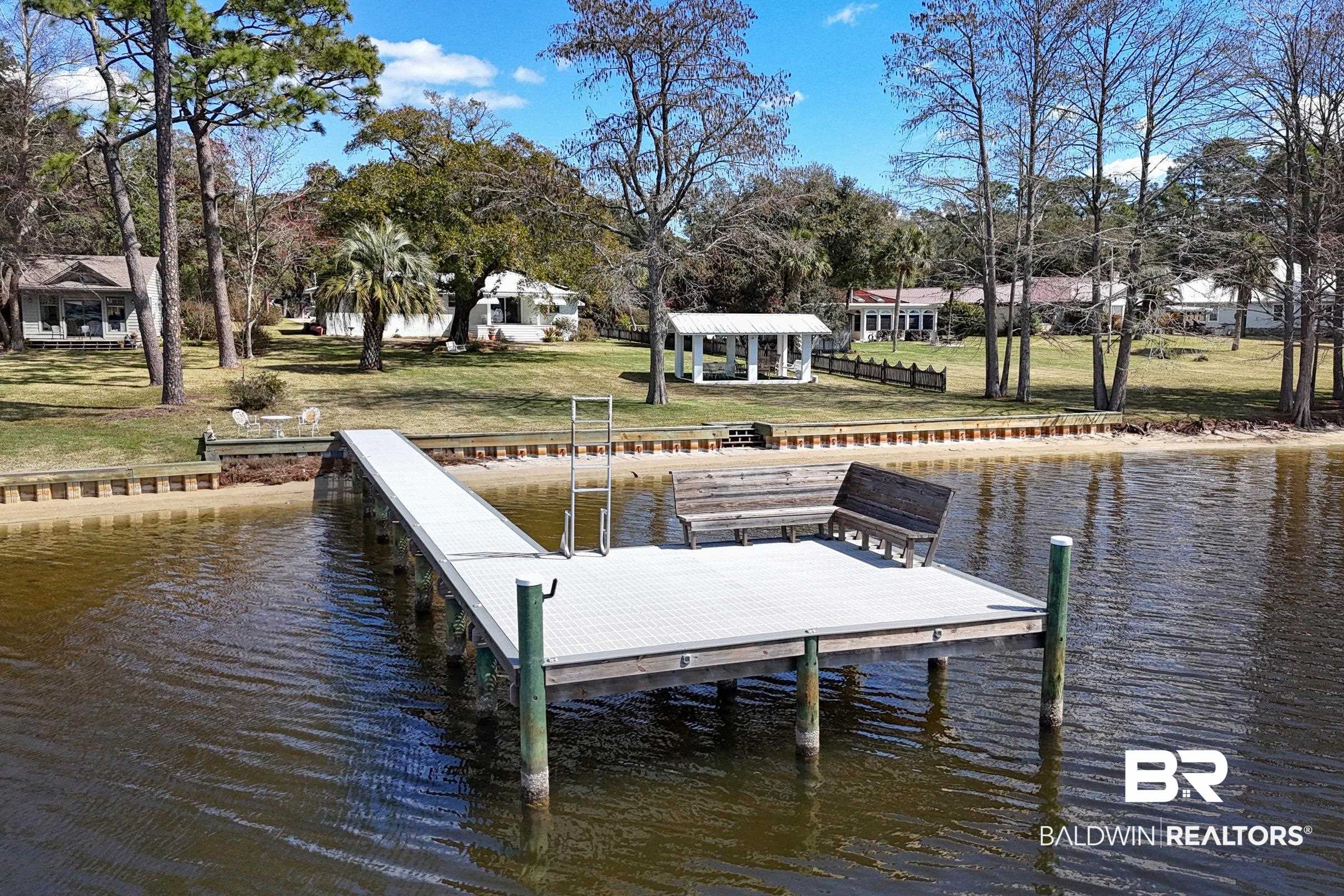 9459 Soldier Creek Road Lillian, AL 36549 - Photo 42 of 54 Dock area with a water view and a lawn