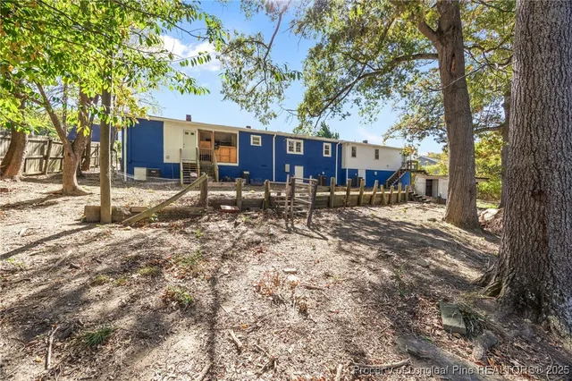 a view of an empty room with wooden floor and a cabinet