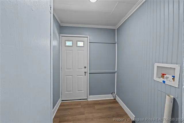 a view of a room with wooden floor and windows