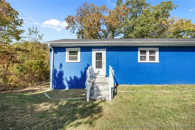 a view of a house with a yard covered in snow