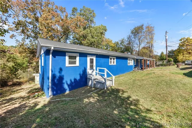 a view of a yard with wooden fence