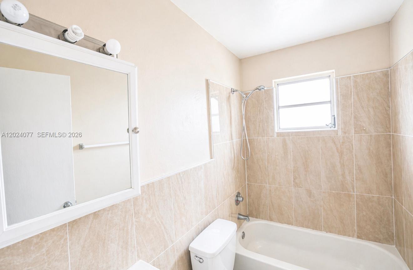2315 West Okeechobee Road, Unit 304 Hialeah, FL 33010 - Photo 5 of 8 a bathroom with a bathtub a shower and a sink