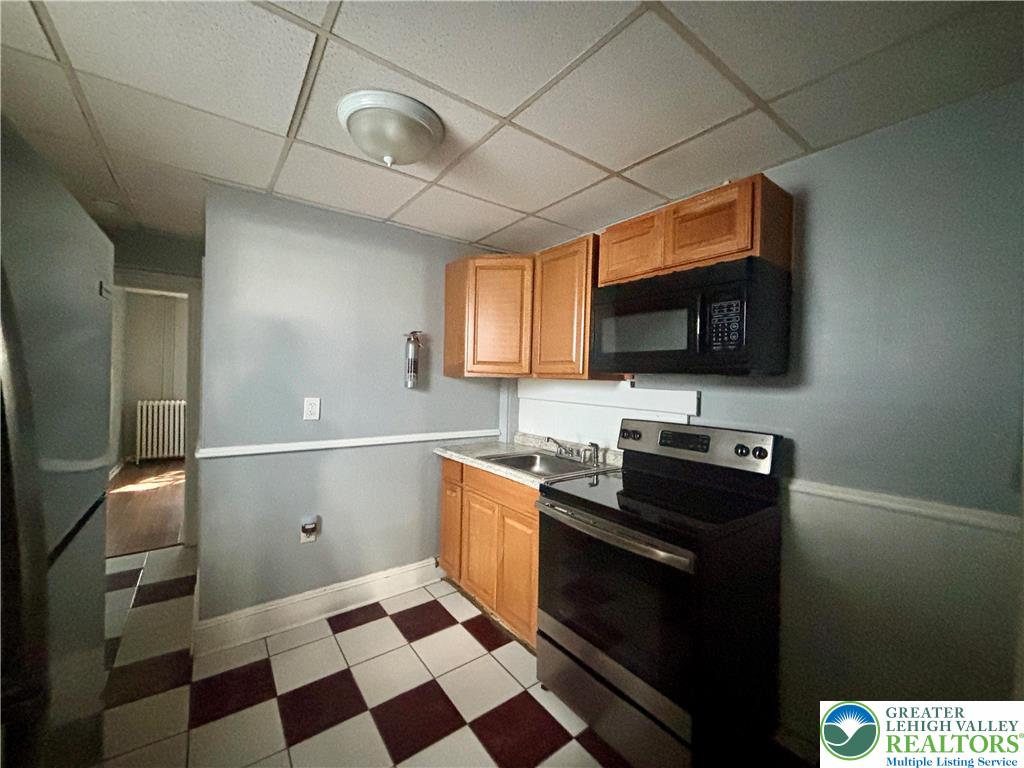 417 McCartney Street, Unit 1 Easton, PA 18042 - Photo 2 of 5 a kitchen with granite countertop stainless steel appliances a sink and a counter space