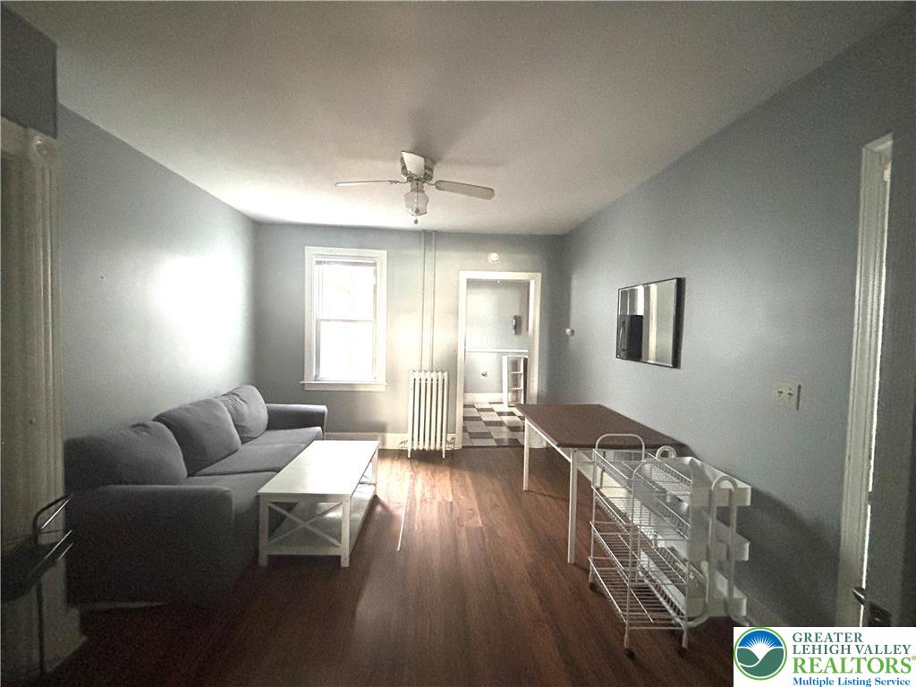 417 McCartney Street, Unit 1 Easton, PA 18042 - Photo 3 of 5 a living room with furniture and wooden floor