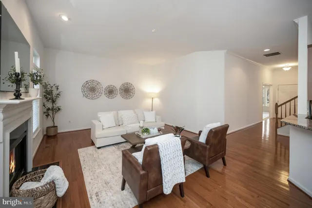 a living room with furniture chandelier and a large window