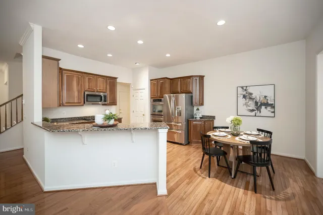 a kitchen with stainless steel appliances granite countertop a sink stove and microwave