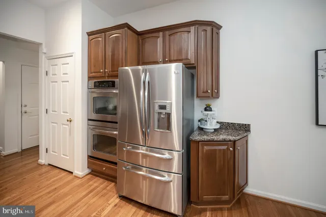 a bedroom with a large bed and a chandelier fan