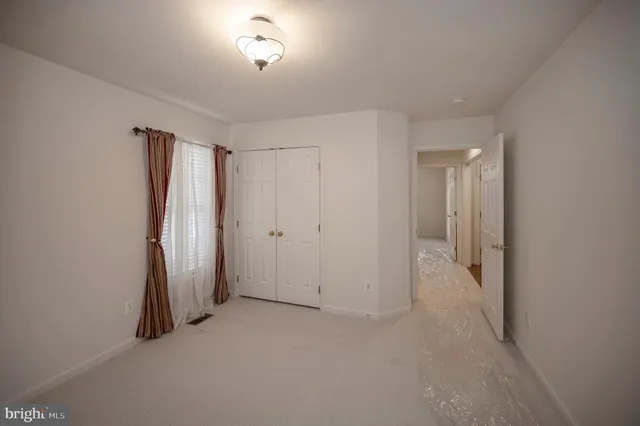 a view of a swimming pool and lounge chairs in back yard