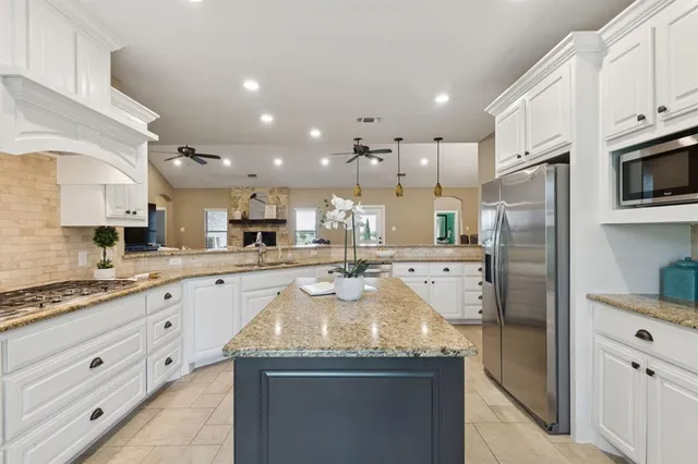 a kitchen with stainless steel appliances granite countertop a sink and cabinets
