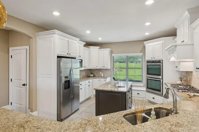 a kitchen with a sink stove and refrigerator