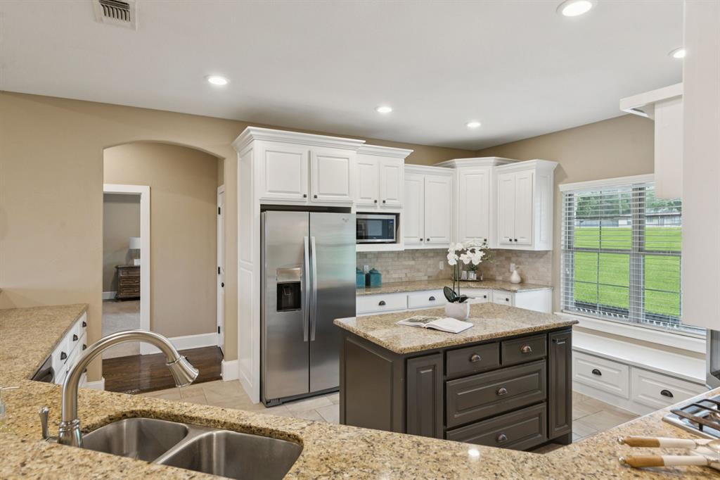 320 Tate Circle Sherman, TX 75090 - Photo 18 of 40 a kitchen with a sink stove and refrigerator