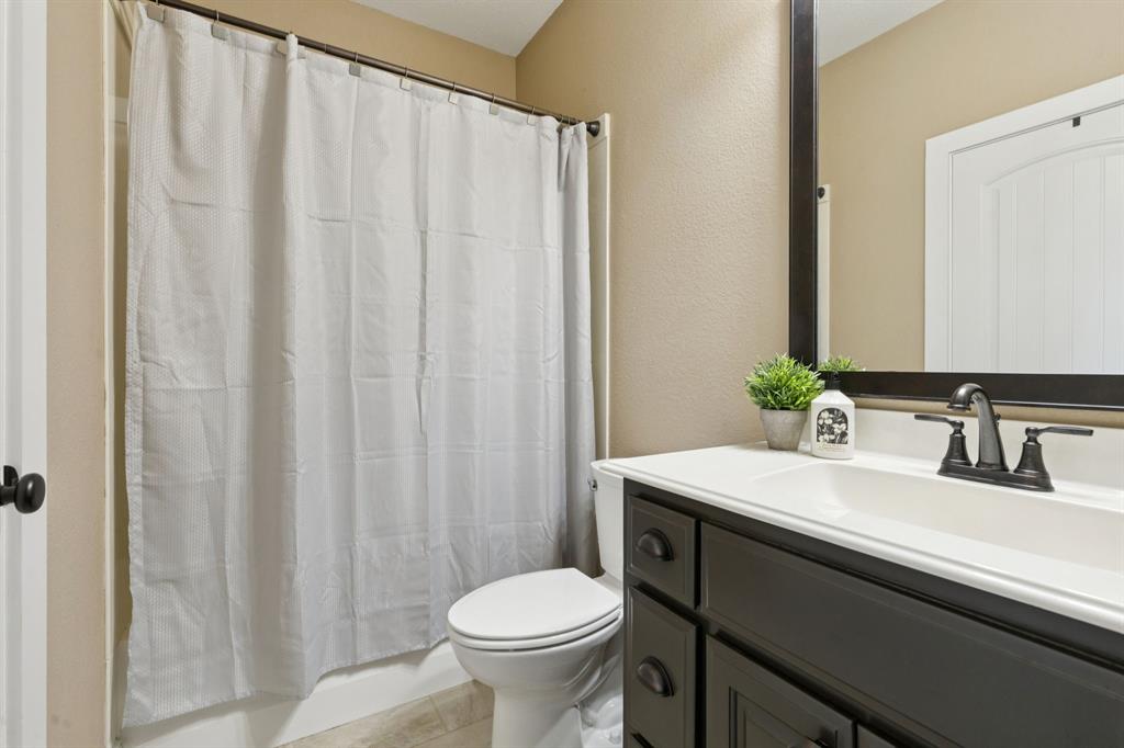 320 Tate Circle Sherman, TX 75090 - Photo 30 of 40 a bathroom with a sink and toilet