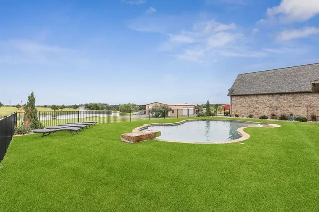 a view of a swimming pool with a yard