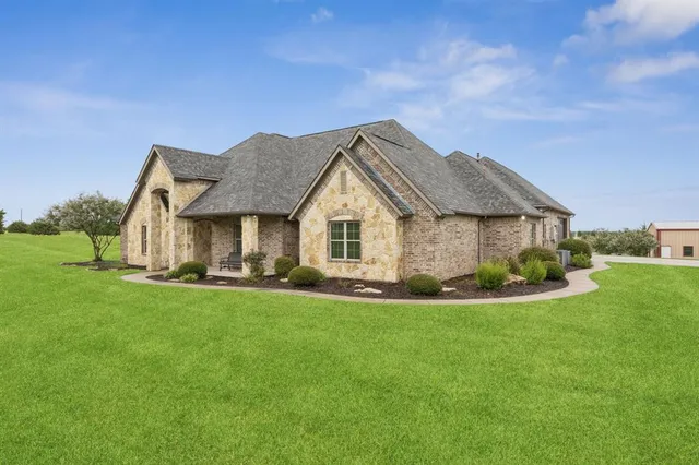 a front view of house with yard and green space