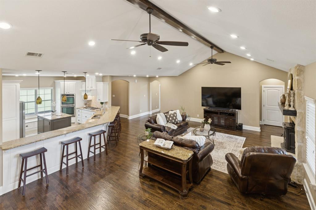 320 Tate Circle Sherman, TX 75090 - Photo 10 of 40 a living room with furniture a flat screen tv and kitchen view